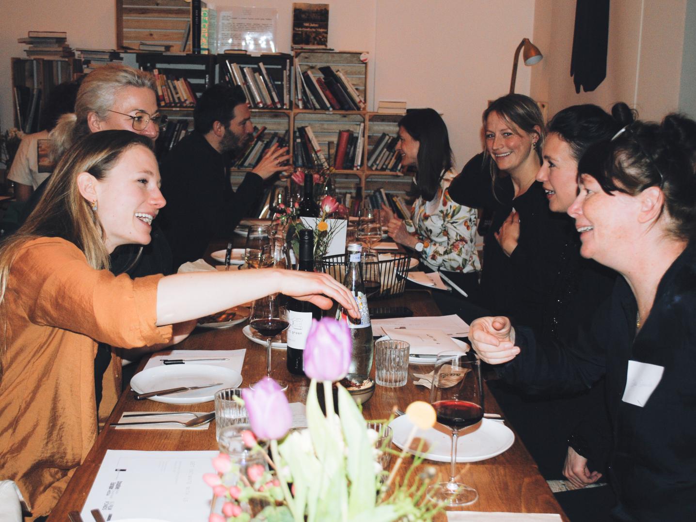 People sitting around a dinner table during the network event Get Intimate With Us in Berlin