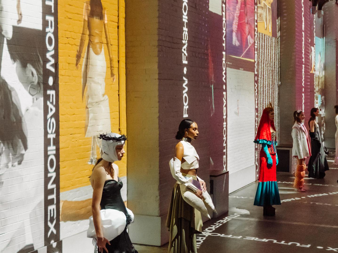 models in front of big screens