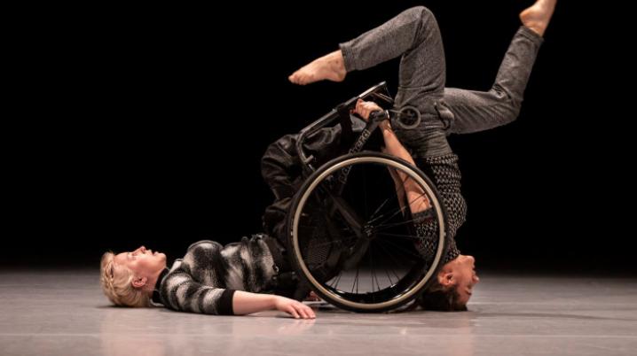 Two professional dancers and a wheel chair on a stage