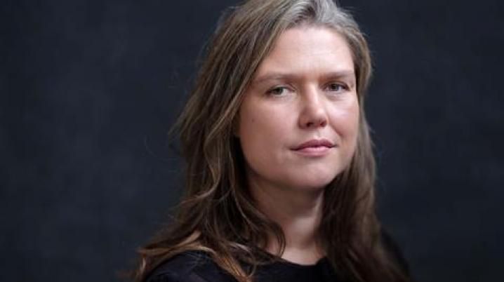 Portrait of a woman with long hair against a dark background