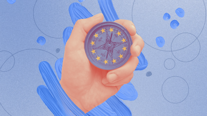 Hand holding compass with European Union stars in circle